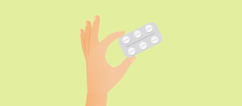 A hand holding prednisone pills